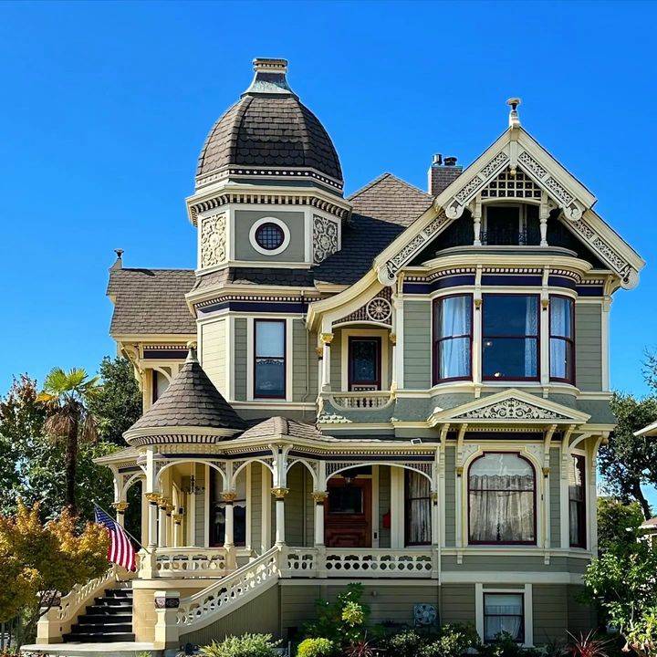 Ornate Victorian mansion with rounded tower and decorative architectural details