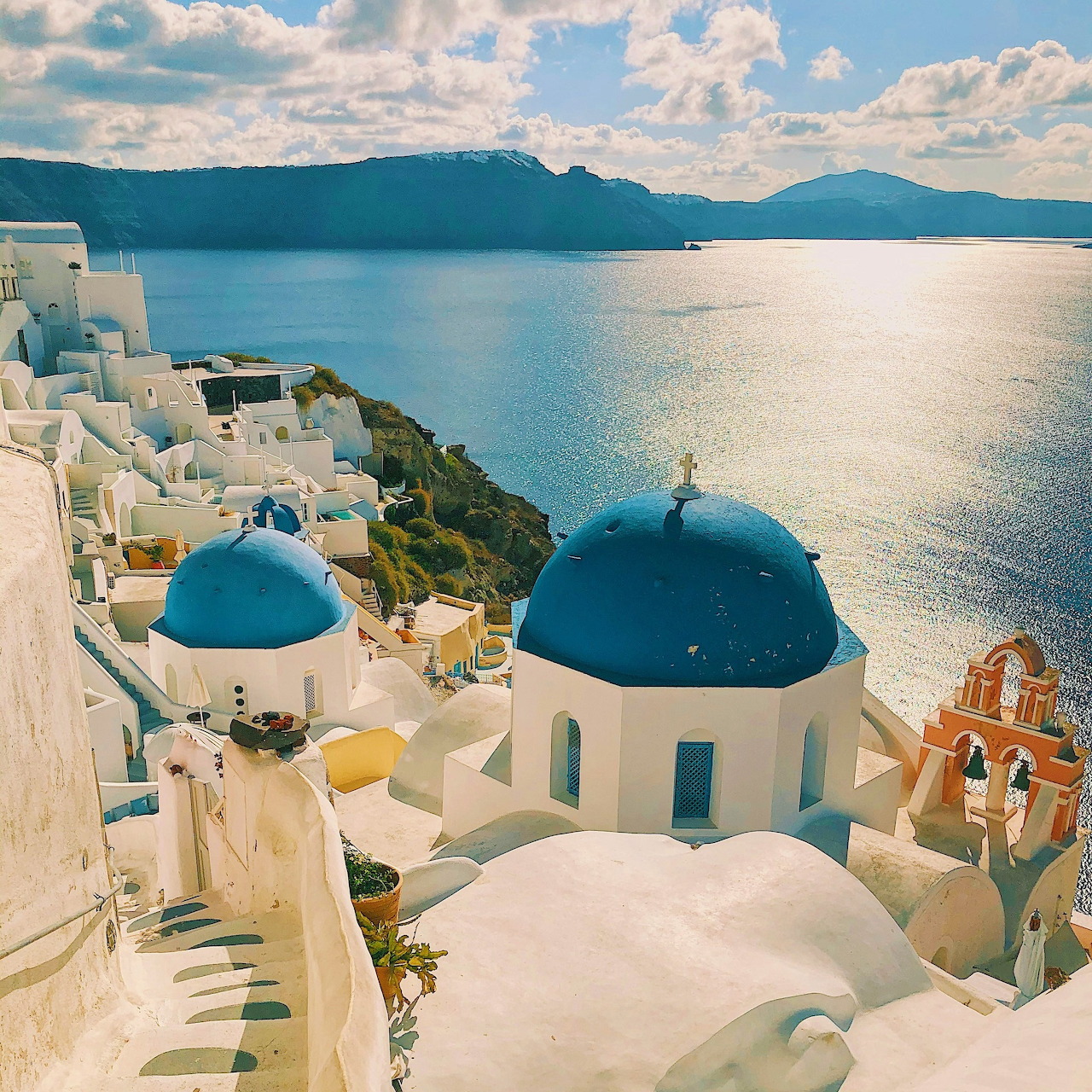 Blue-domed churches and white buildings overlooking the sea in Santorini, Greece