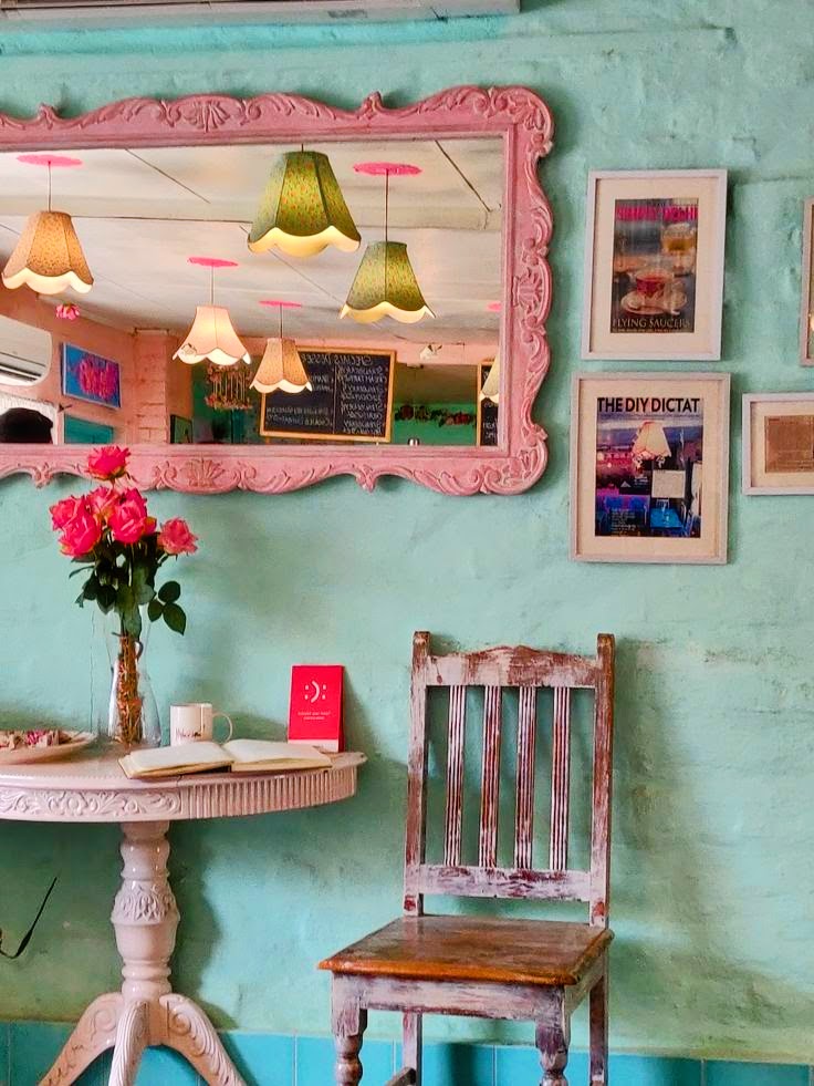 Pastel pink and mint themed cozy cafe interior with decorative seating