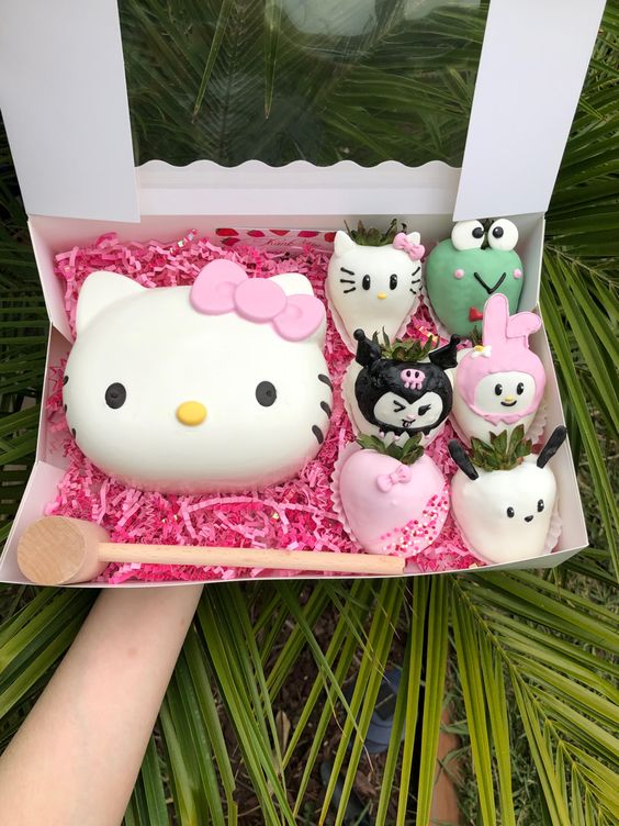 White gift box containing Hello Kitty cake and strawberry character desserts
