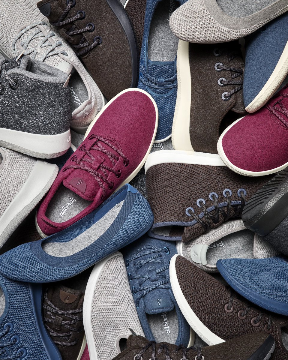 Assorted casual sneakers in different colors arranged in a circle viewed from above