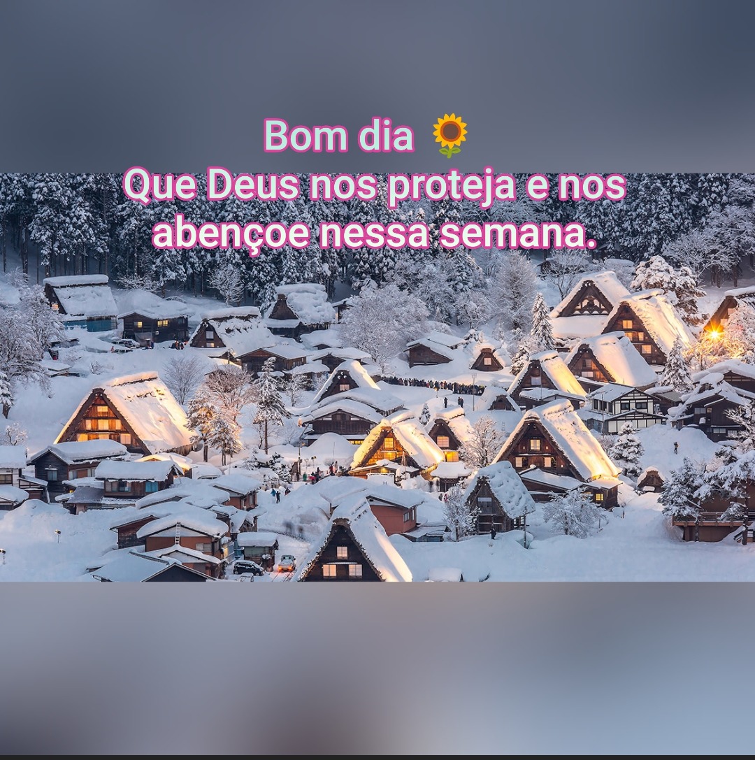 Snowy village with warmly lit houses and Portuguese greeting text at the top