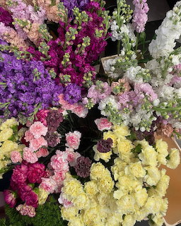 Overhead view of colorful flower bouquet with purple, pink, yellow and white blooms clustered together