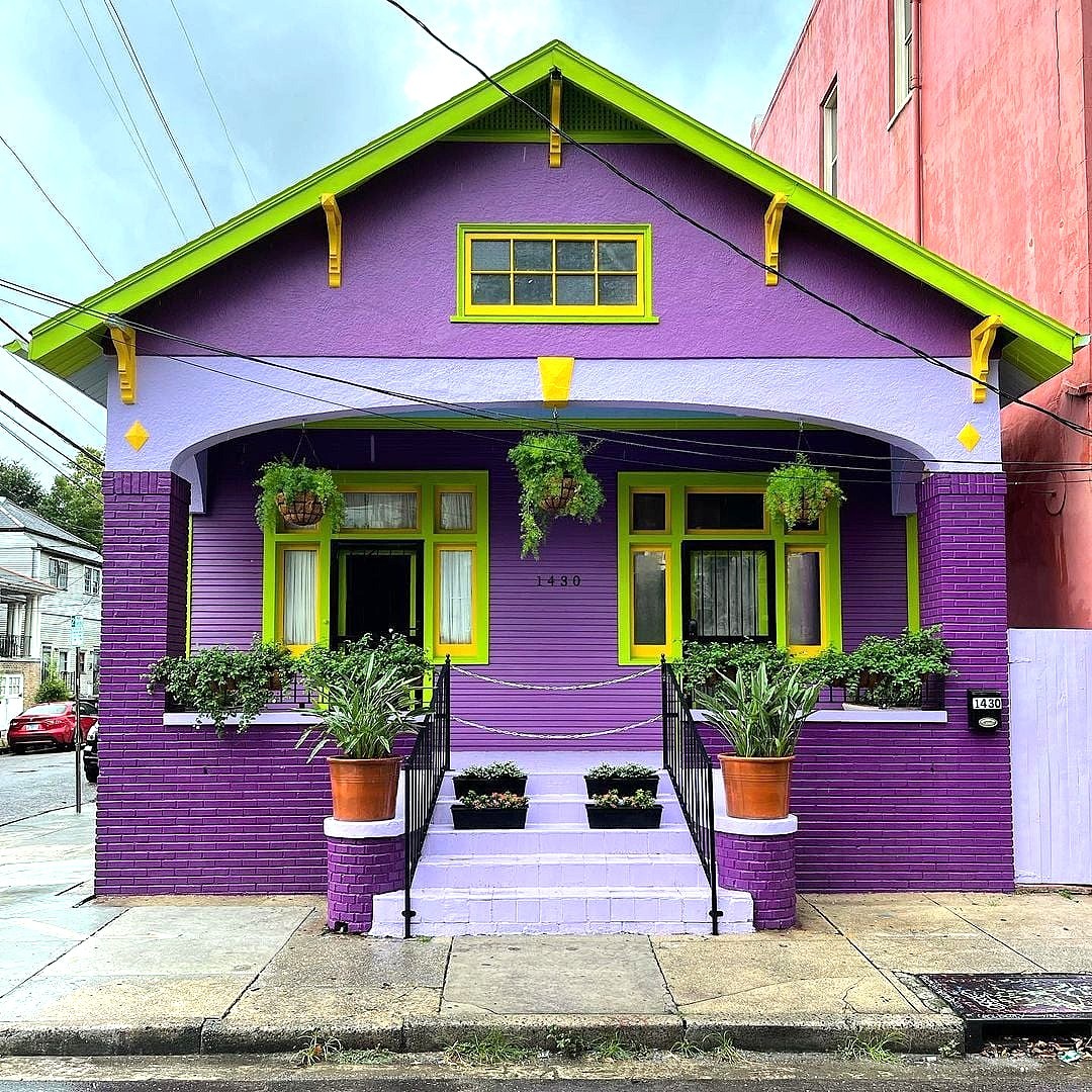 Purple house with bright green trim and front porch