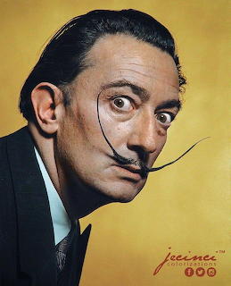 Portrait photo of Salvador Dalí with his signature upturned waxed mustache on yellow background