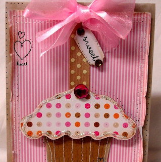 Handmade card with fabric cupcake decoration, polka dots, pink stripes, and ribbon bow