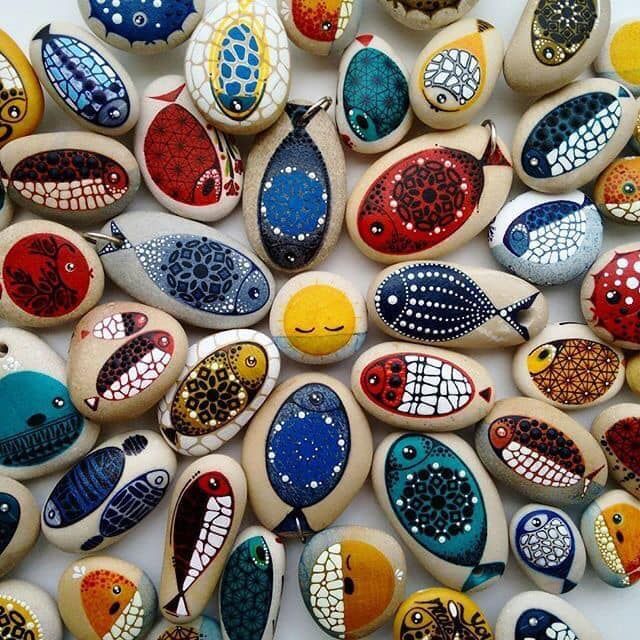 Colorful painted pebbles with dotted and patterned designs arranged together