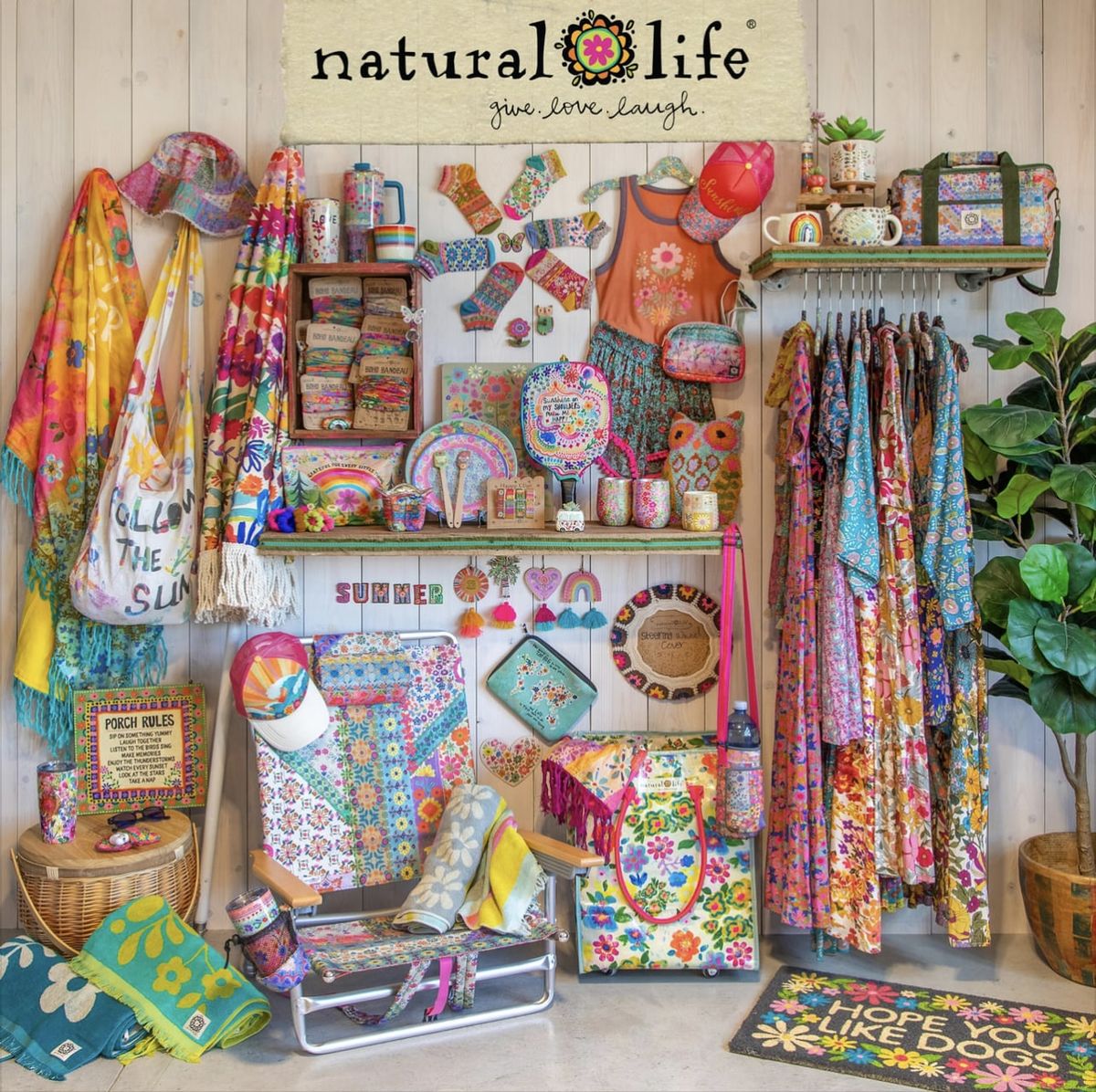Colorful craft supply shelf with fabrics, patterns, and sewing materials arranged on white wood paneling