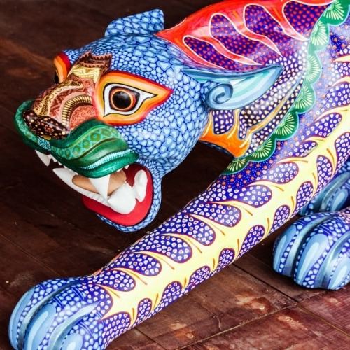 Colorful Mexican alebrije wooden sculpture with intricate painted patterns in blue, purple, and orange