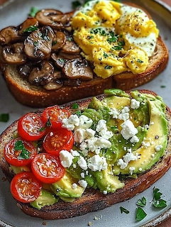 Two gourmet open-faced toasts with avocado, cherry tomatoes, feta, mushrooms, and scrambled eggs on a plate