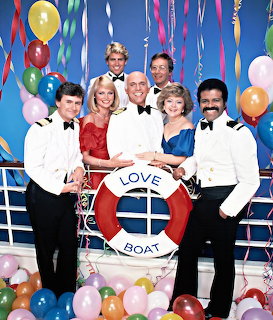 The Love Boat cast posing with a life preserver ring surrounded by colorful balloons and streamers
