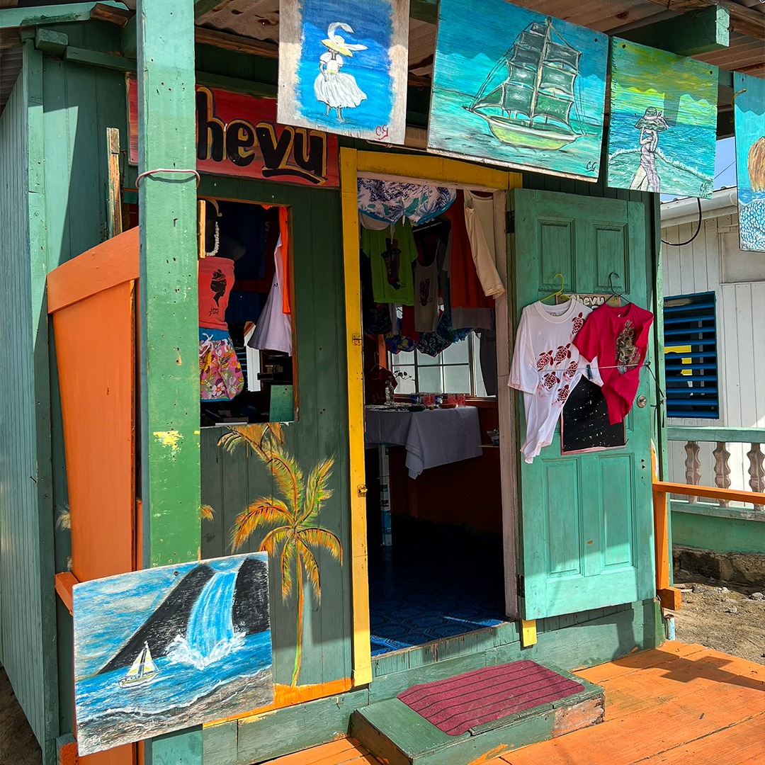 Colorful beach shop with painted surfboards and tropical artwork on turquoise and orange walls