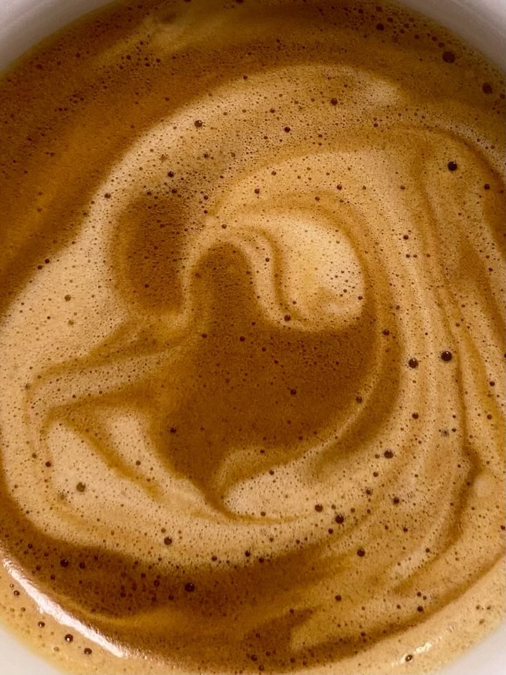 Close-up of swirling latte art in a cup of coffee