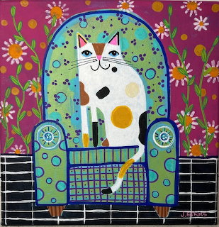 Colorful folk art painting of a white cat with orange and black patches sitting in a decorative chair with flowers