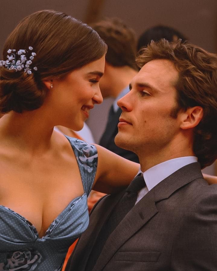 Couple in formal evening wear gazing at each other intimately at an elegant event