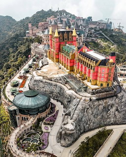 Aerial view of Ba Na Hills castle complex on a misty mountaintop in Da Nang, Vietnam
