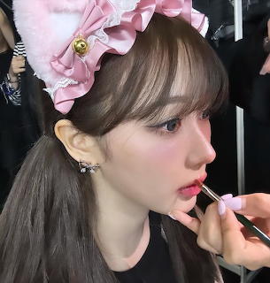 Woman Applying Lipstick
