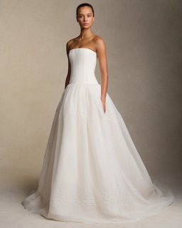 Woman wearing a strapless white wedding dress with corset bodice and full skirt