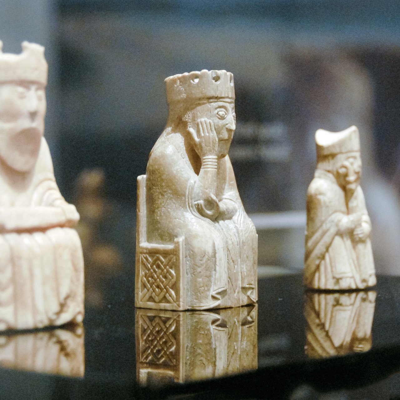 Ivory Lewis Chessmen medieval chess pieces on display, featuring ornately carved king figure with crown and detailed robes