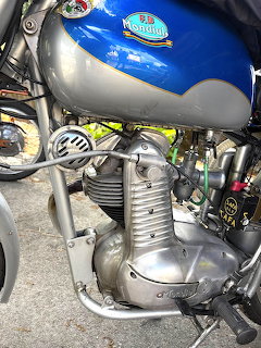 Vintage FB Mondial motorcycle engine with chrome exhaust pipes and blue painted fuel tank