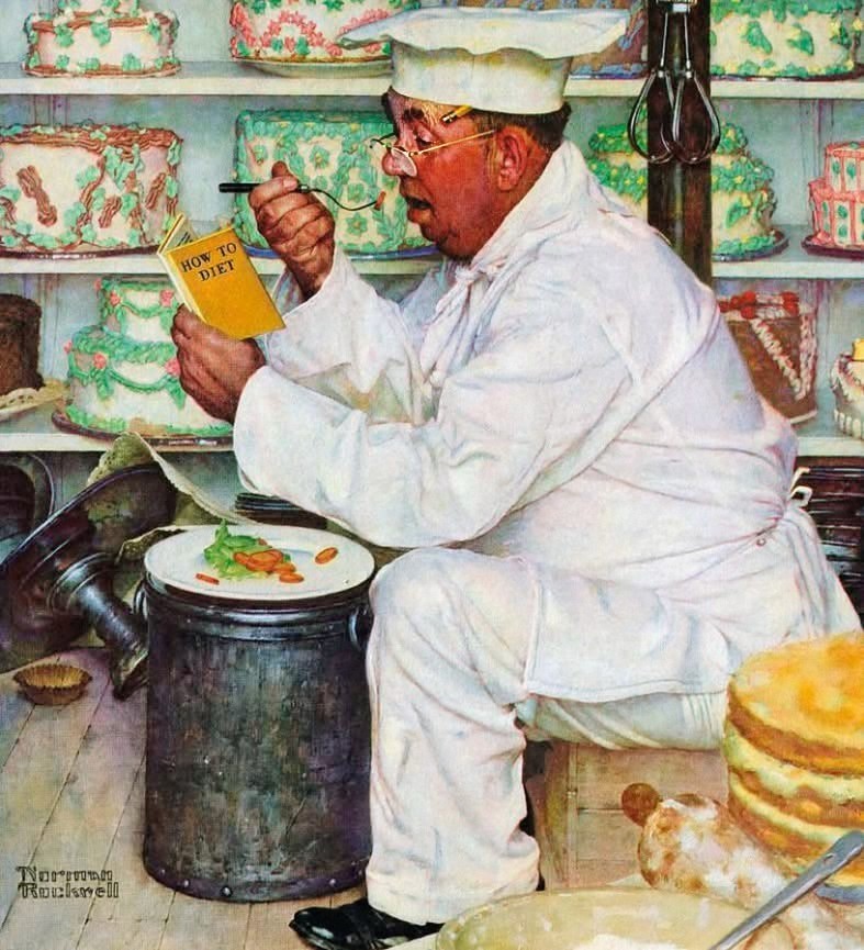 Overweight chef in white holding juice glass, sitting by small salad with desserts on shelves behind him