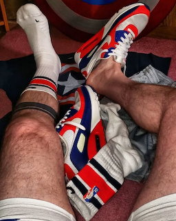 Person's legs wearing white sneakers and white sports socks