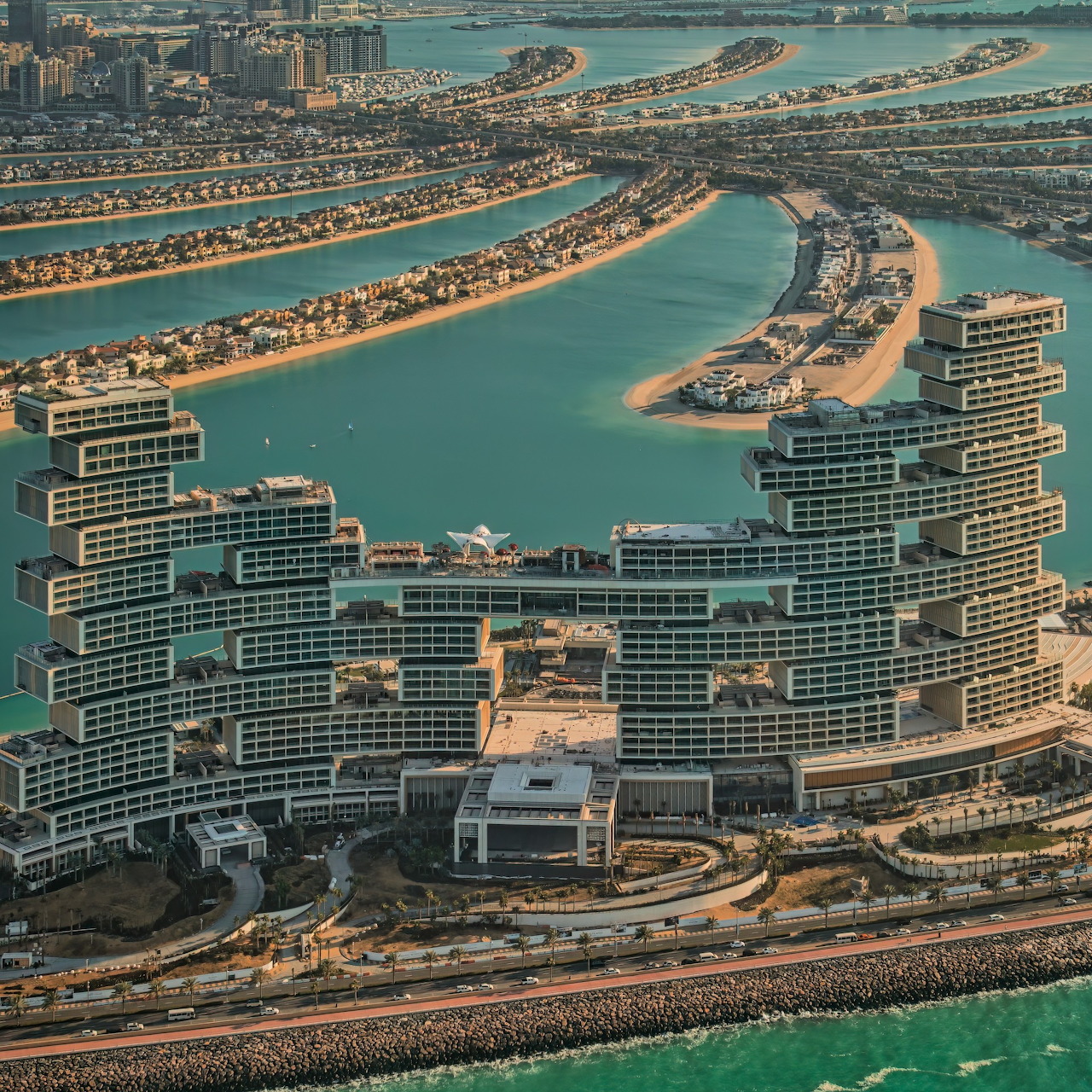 Aerial view of Atlantis The Royal hotel on Palm Jumeirah in Dubai with turquoise water and curved islands