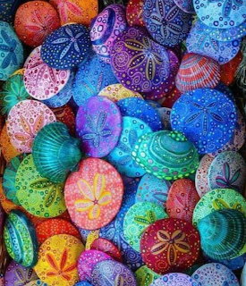 Colorful painted sea urchin shells and sand dollars with intricate decorative patterns