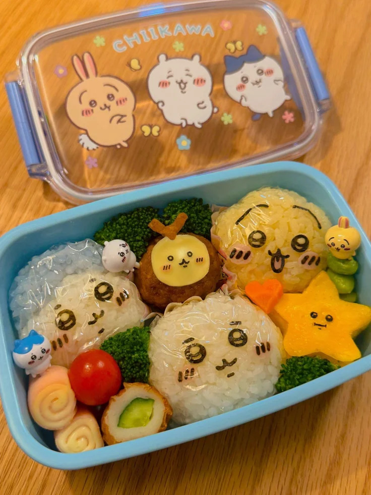 Kawaii Chiikawa character bento box with cute rice shapes and colorful sides