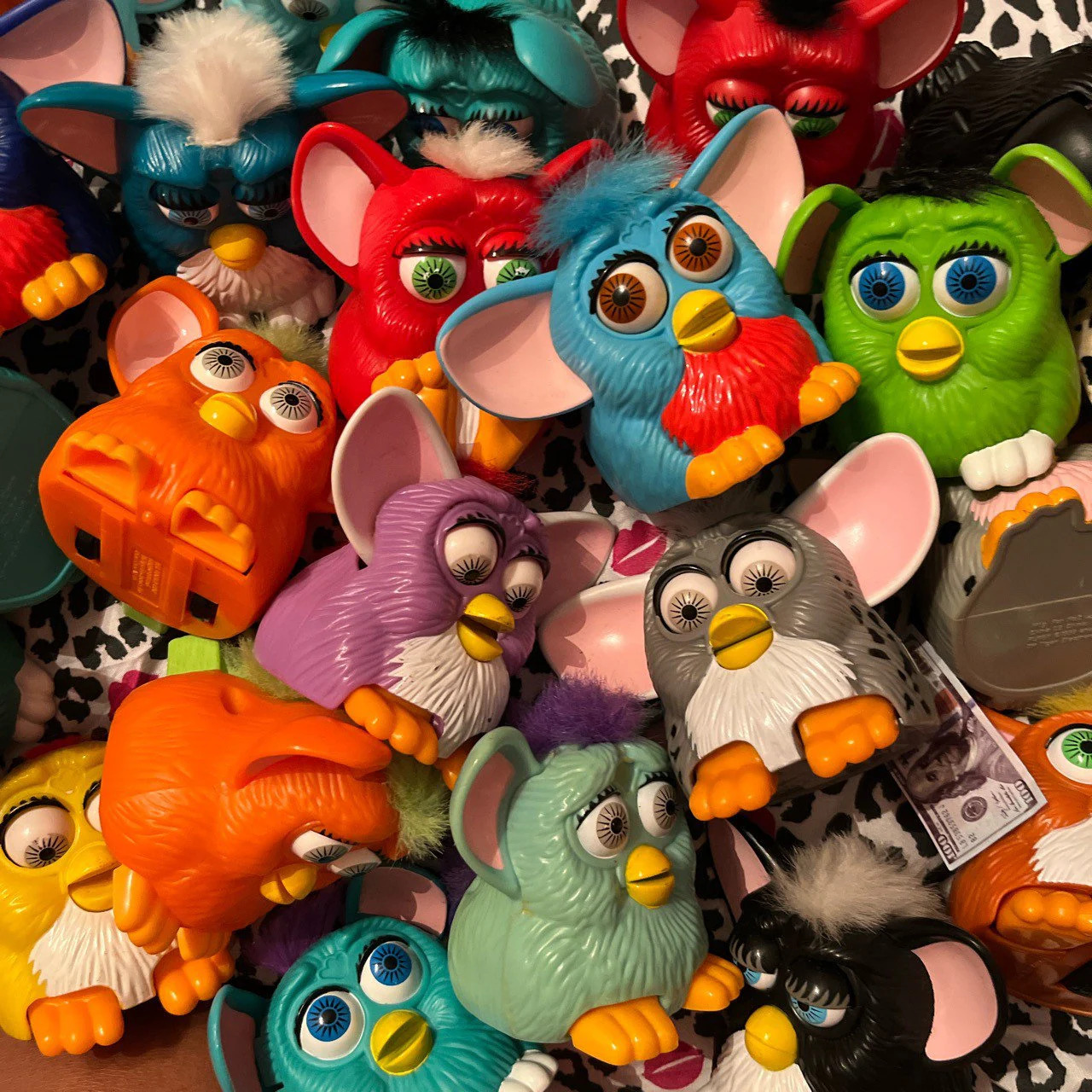 Close-up of colorful Furby toy figures piled together