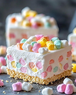 Mini cheesecake slice topped with colorful mini marshmallows and graham cracker crust