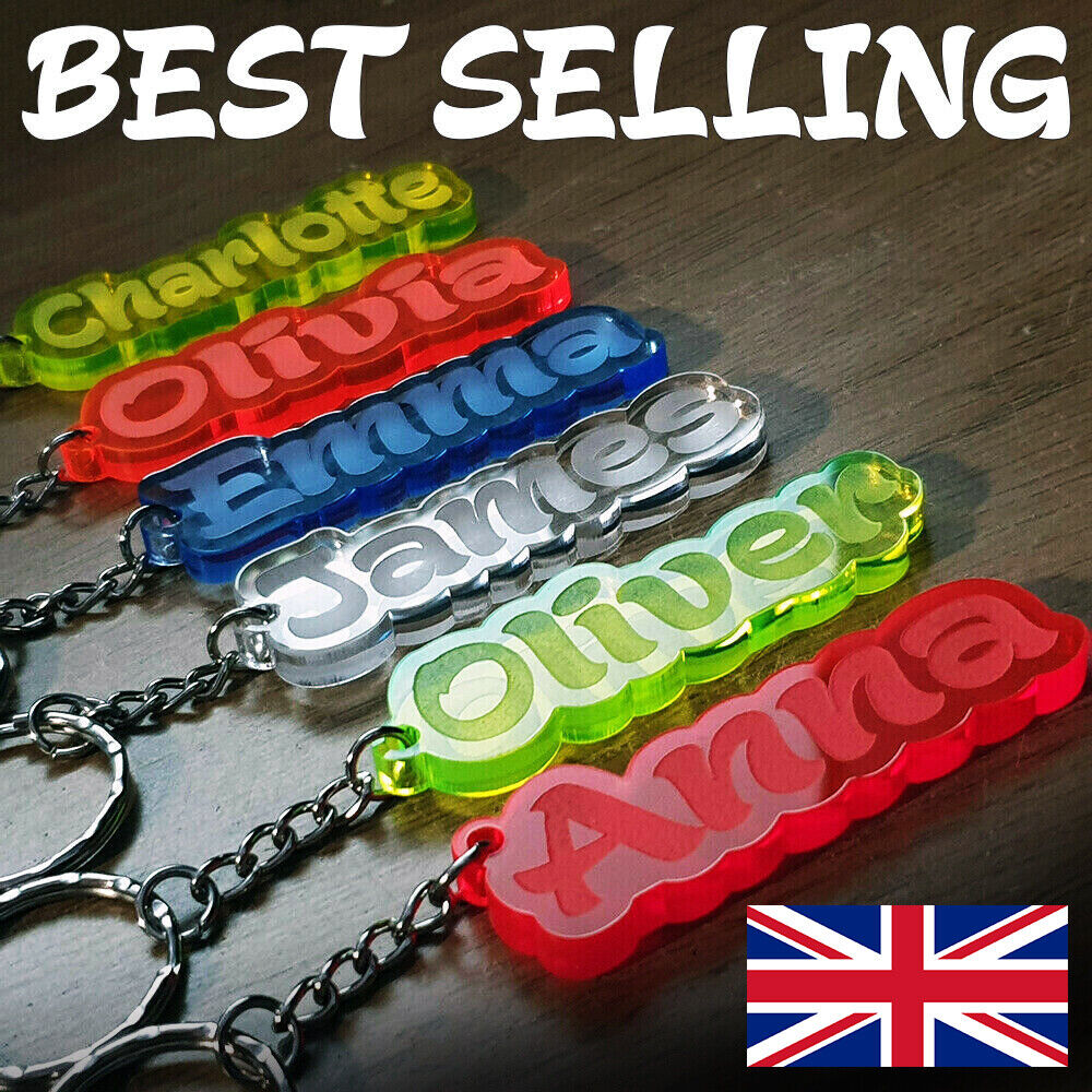 Colorful personalized acrylic name keychains on a wooden surface with a small UK flag