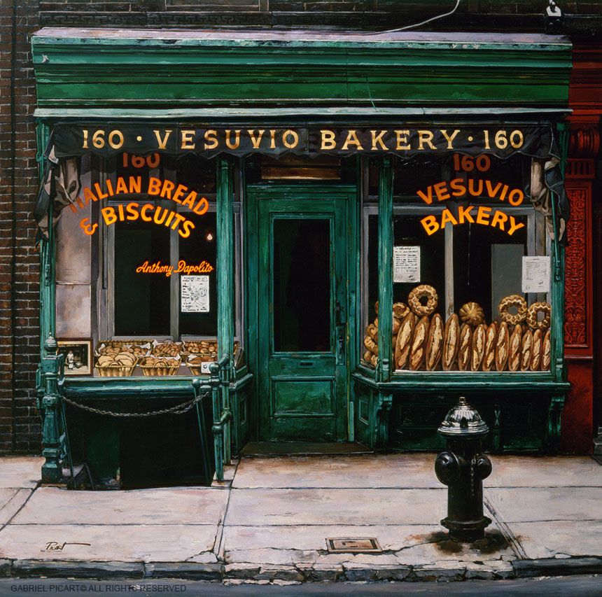 Vintage green bakery storefront with bread in the display windows and a fire hydrant outside