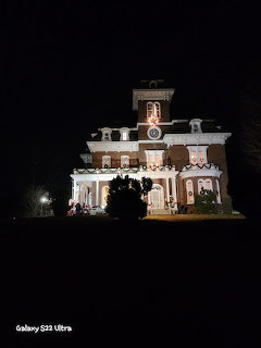 Large house decorated with Christmas lights at night