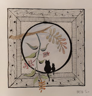 Two black cats sitting on branch with autumn leaves in circular frame
