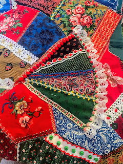 Colorful vintage patchwork fabric pieces with floral prints and lace trim