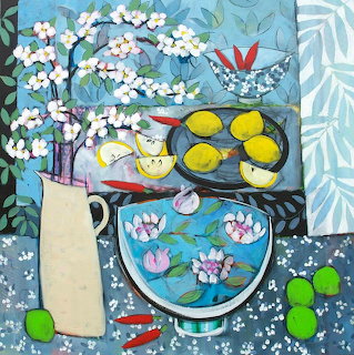 Painting of still life with bowl of water lilies, lemons, white flowers in vase, and patterned fabrics