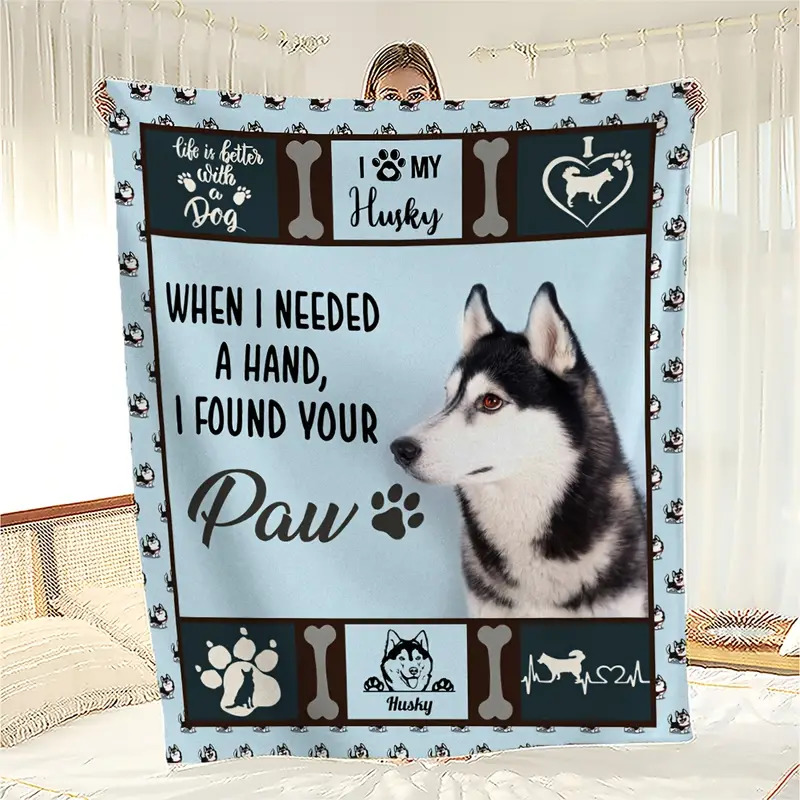 Light blue blanket with a black and white husky portrait and dog-themed text hanging indoors