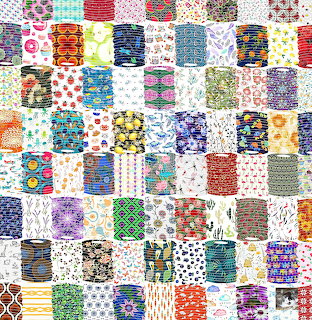 Colorful patchwork quilt with diverse fabric patterns in grid arrangement
