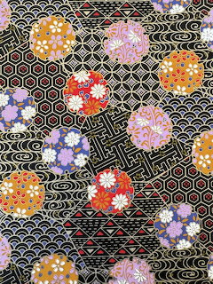 Colorful Japanese pattern with floral circles on black background with geometric designs