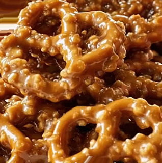 Close-up of toffee-coated pretzels with shiny caramel glaze piled on a surface