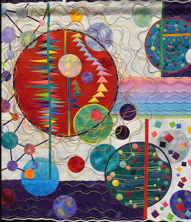 Abstract art quilt with overlapping colorful circles, geometric patterns, and detailed quilted stitching on textile fabric