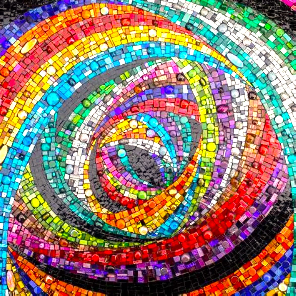 Colorful mosaic spiral with rainbow glass tiles swirling in circular pattern