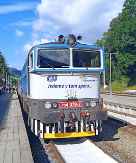 White and blue locomotive at railway platform
