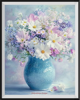 Pastel flower bouquet with daisies and tulips in a blue ceramic vase against a light blue background