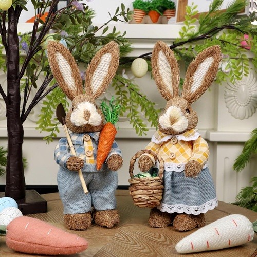 Two decorative Easter bunny figurines in denim outfits with basket and carrots