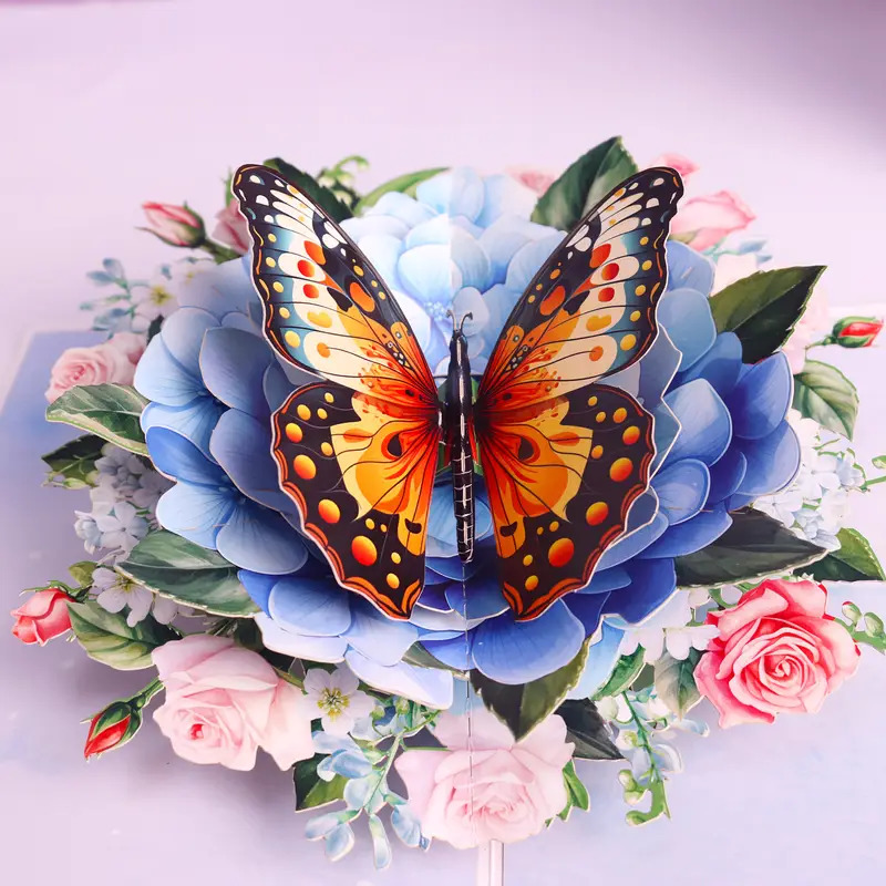 Orange butterfly perched on blue flower with pink roses