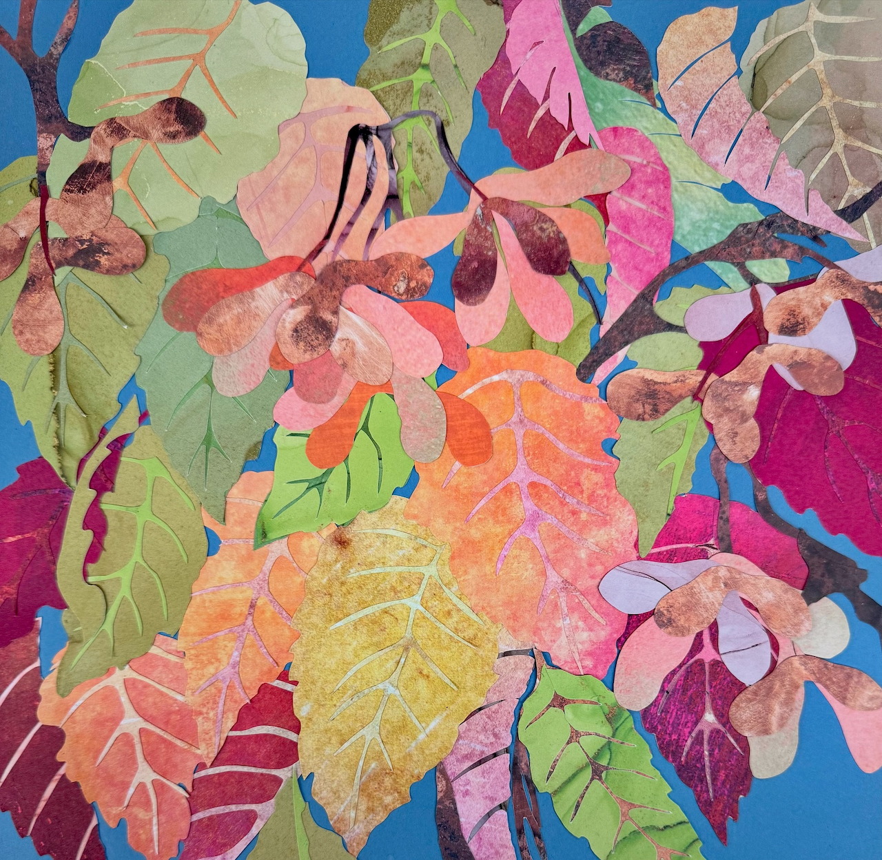 Colorful painting of overlapping leaves and flowers on a blue background