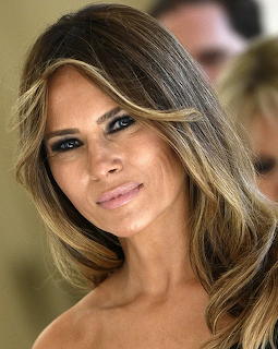 Close-up portrait of Melania Trump with long highlighted hair and soft makeup