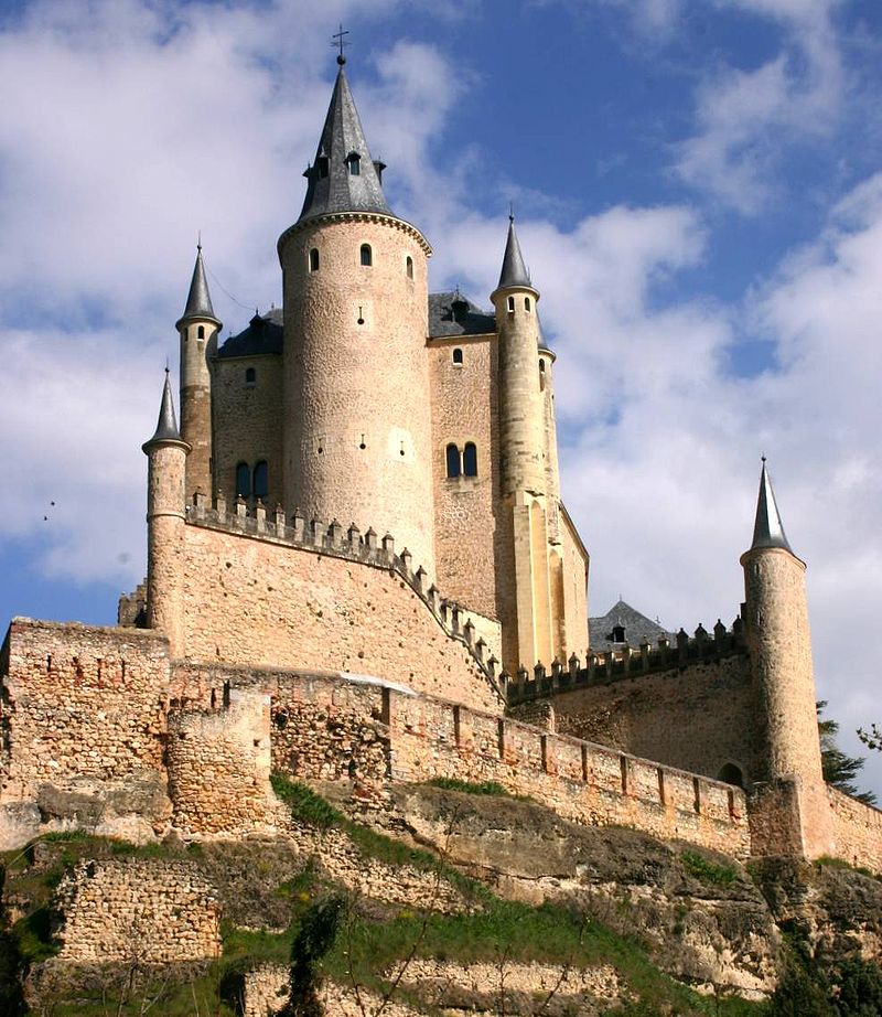 Alcázar of Segovia castle perched on a rocky cliff with cylindrical towers and stone walls